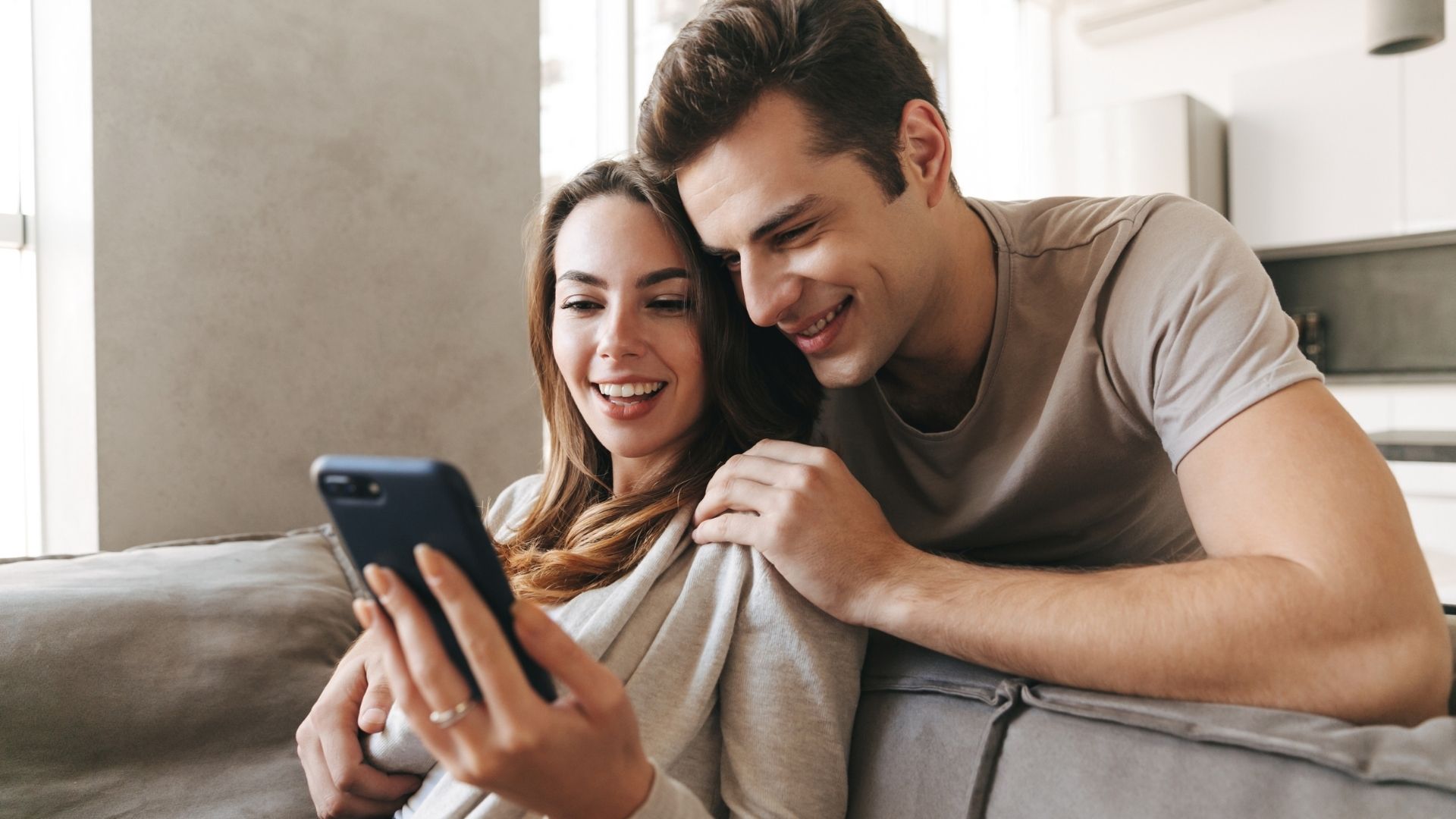 Couple viewing a San Antonio home virtually on laptop with realtor support